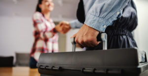 Facility maintenance technician arriving on-site with equipment